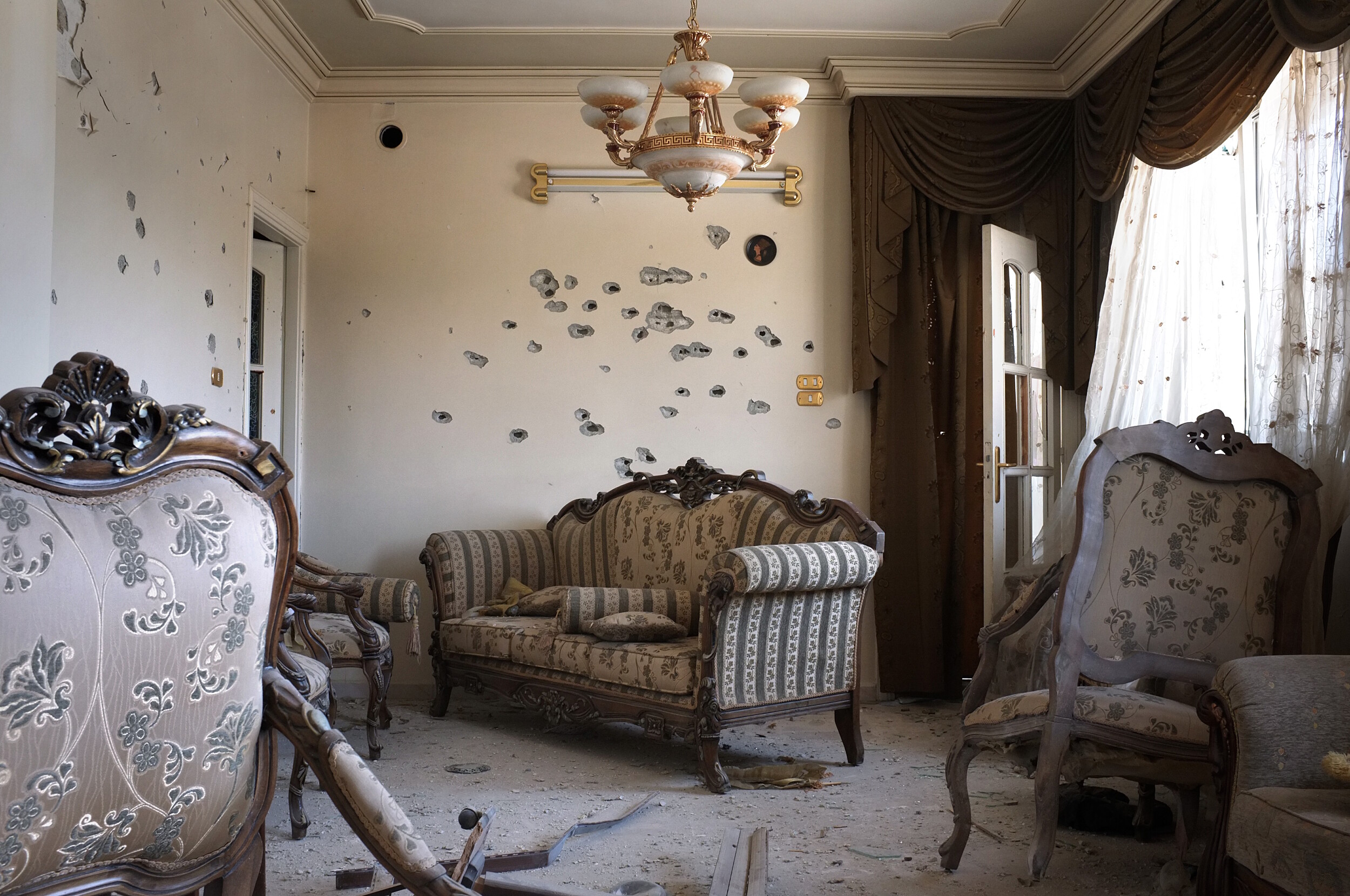 In a house on the border of Baba Amr, Homs bullet holes riddle the walls and furniture. Blocks of the city were abandoned and most shops were closed.