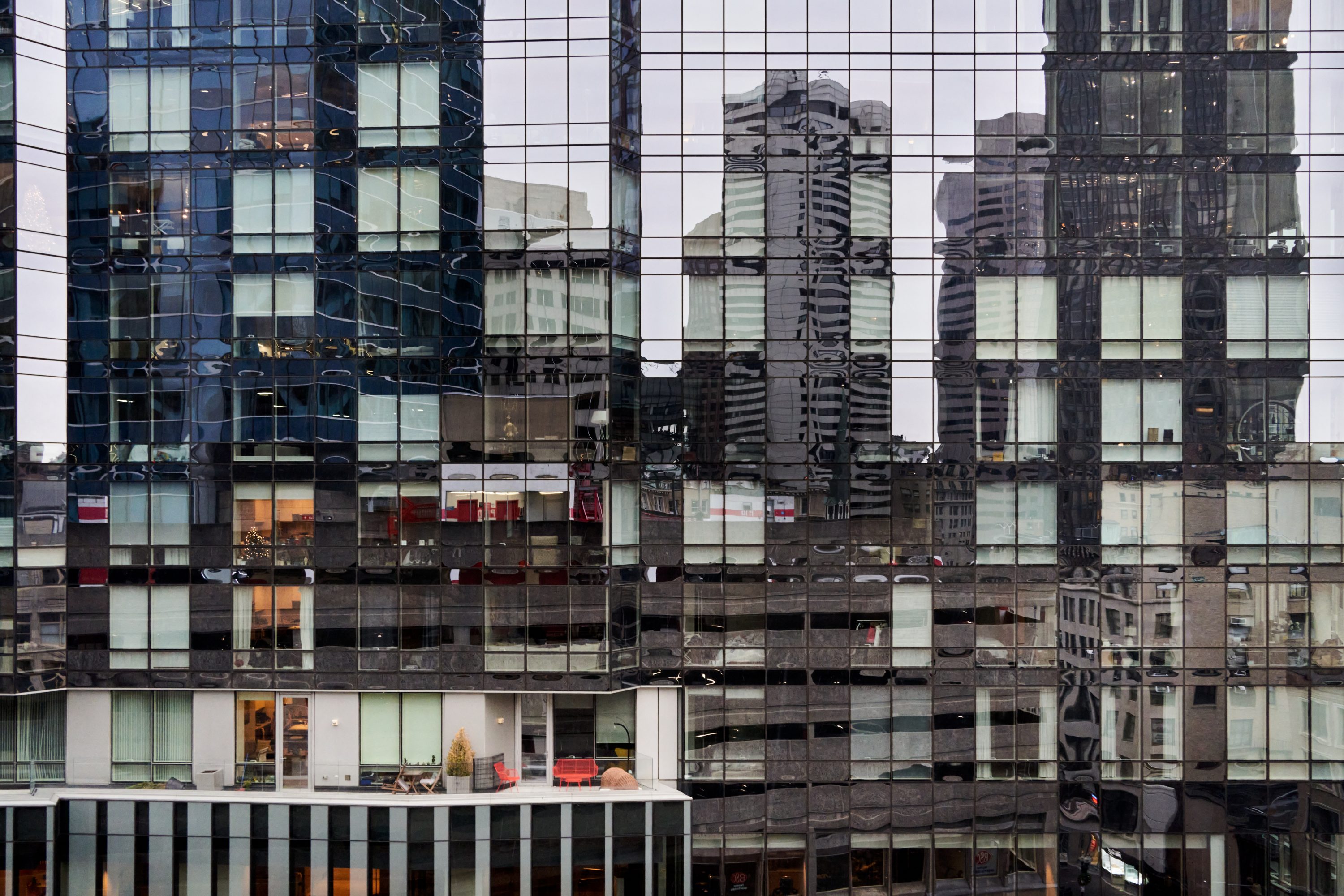 Buildings of downtown Boston are reflected in the Millennium Tower in Boston, Massachusetts.